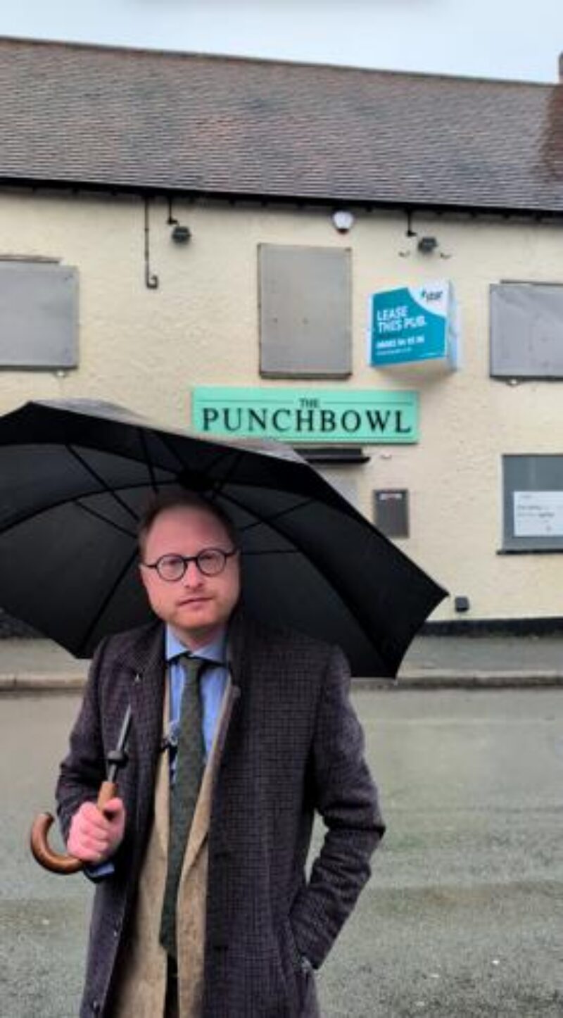 Jonathan Davies MP standing in front of the Punch Bowl pub.